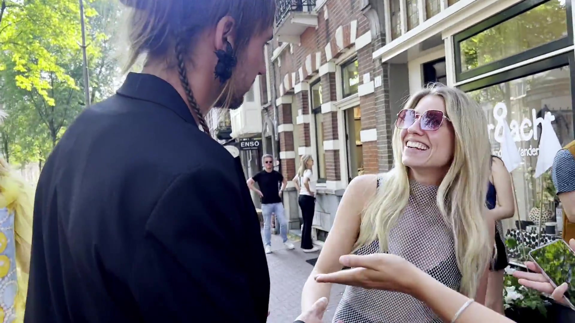 A stranger draws Jennifer into a scene on an Amsterdam street